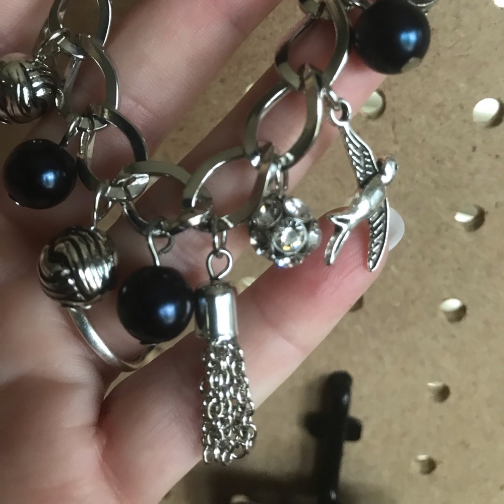 Silver bracelet w/dark blue stones & silver charms
